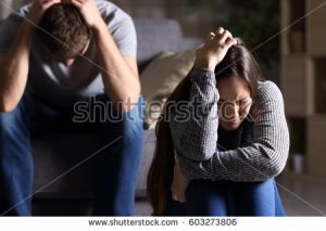 stock-photo-sad-couple-after-argument-or-breakup-sitting-on-a-sofa-in-the-living-room-in-a-house-indoor-with-a-603273806